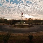 Flags on a pole in the middle of a traffic circle